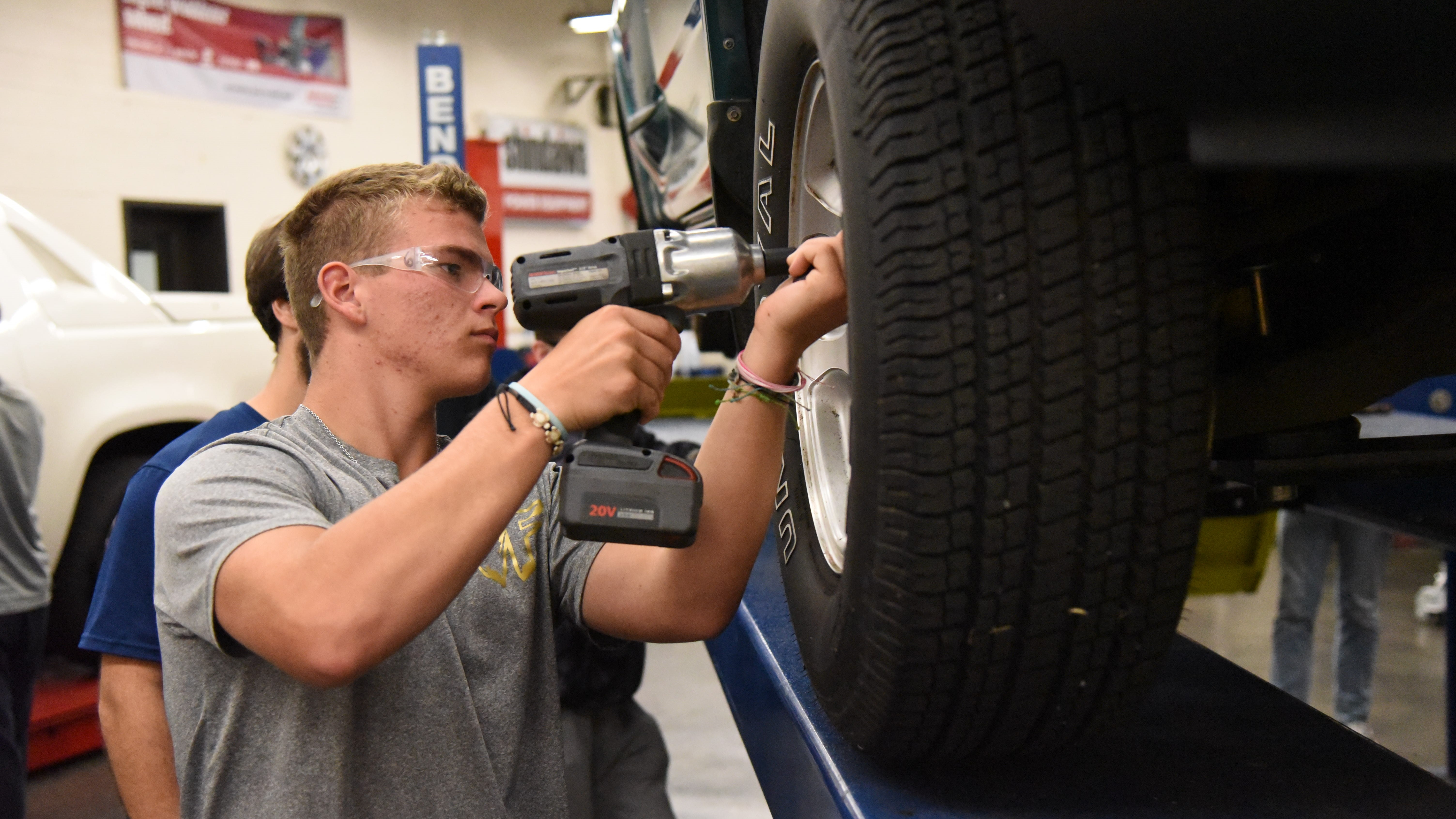 Bryson Harvey, a senior at Gibbs High School, works on a vehicle during a CTE class on Oct. 15, 2019. 